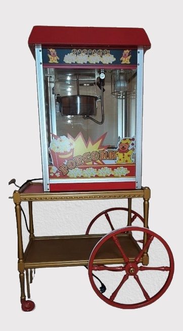 Popcornmaschine auf einem Wagen, rot und blau dekoriert.